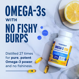 Omega-3 2100 Minis: fish-burp-free capsules and lemon on marble with bold text—no fishy burps!.