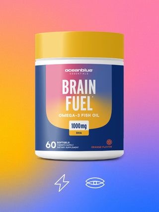 A container labeled Oceanblue Essentials Brain Fuel Omega-3 Fish Oil, 1000mg DHA, Orange Flavor with 60 softgels, on a vibrant pink, orange, and blue gradient background, featuring icons of a lightning bolt and an eye.