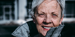Older woman with white hair smiling