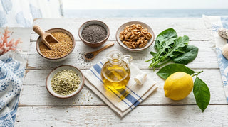 Flat-lay of plant-based omega-3 foods including flax, chia, walnuts, and oil on white wood