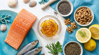 Amber omega-3 softgels in a glass dish surrounded by salmon, sardines, walnuts, and lemon on a white surface