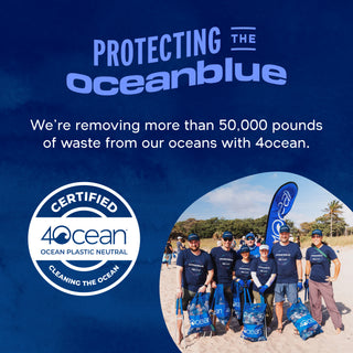A group in matching blue shirts and hats hold Omega-3 2100 MG bags on the beach, promoting ocean wellness.